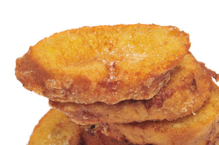 a pile of torrijas, typical Lent spanish sweet, on a white background