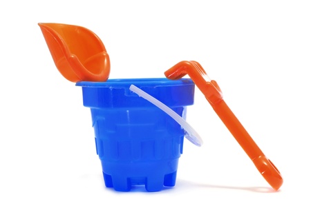 a castle bucket with shovel and rake on a white backgroundの写真素材