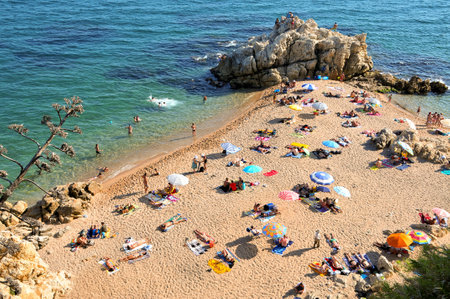 Sant Pol de Mar, Spain - August 17, 2011: La Roca Grossa Beach in Sant Pol de Mar, Spain. The Catalan coast, where is Sant Pol de Mar, is the destination of millions of tourists in the summerのeditorial素材
