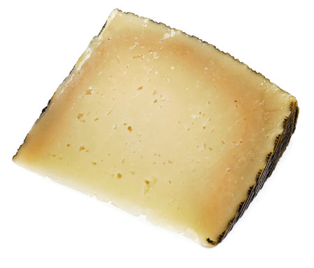 a piece of manchego cheese on a white background