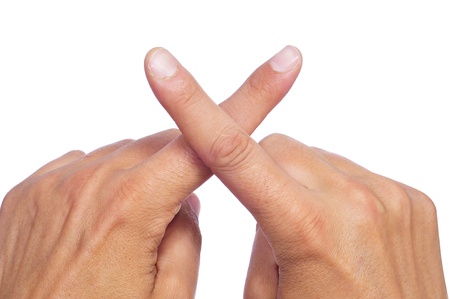 man hands crossing fingers forming an xの写真素材