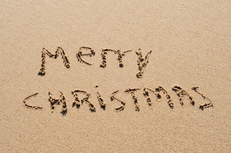 sentence merry christmas written in the sandの写真素材