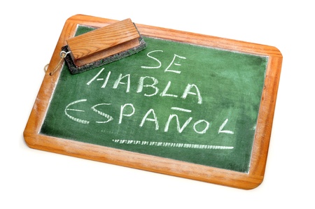 sentence Spanish is spoken written in spanish on a chalkboardの写真素材