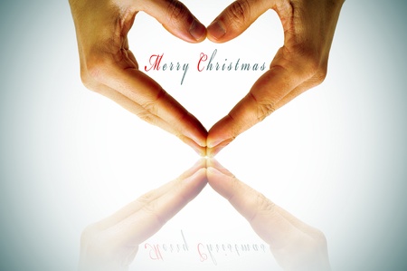 hands forming a heart and the sentence merry christmasの写真素材