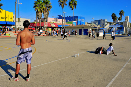 Venice, US - October 16, 2011: Basketball players in Venice Beach in Venice, US. A lot of people use to play basketball on the courts placed in the Ocean Front Walk of Venice Beachのeditorial素材