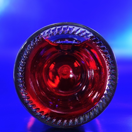 closeup of the bottom of a red sparkling wine bottleの写真素材