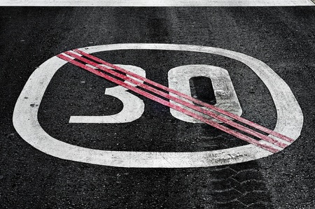 end of speed limit sign painted on the roadの写真素材