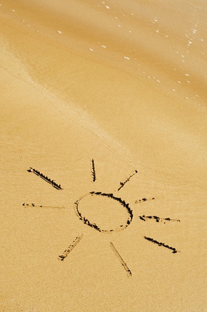 a sun drawn on the sand isolated on a white backgroundof a beachの写真素材