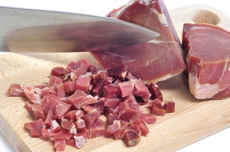 a pile of diced spanish serrano ham on a chopping boardの写真素材