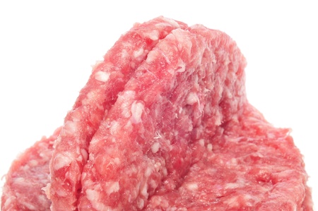closeup of some raw burgers on a white backgroundの写真素材