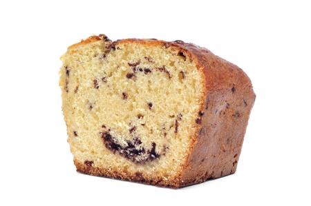 a piece of sponge cake with chocolate chips on a white backgroundの写真素材