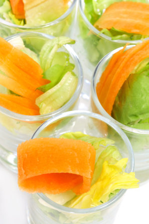 closeup of some shot glasses with salad
