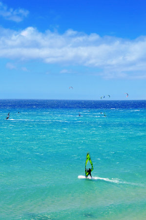 Fuerteventura, Spain - June 22, 2012: Windsurfers and kitesurfers in Sotavento Beach in Fuerteventura, Canary Islands, Spain. The Windsurfing and Kiteboarding World Cup is held every year in this beachのeditorial素材