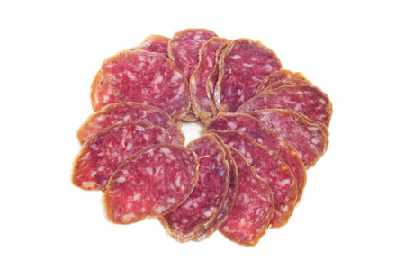 a pile of slices of salchichon, spanish salami, on a white backgroundの写真素材