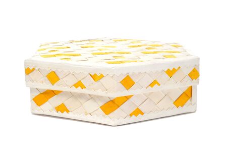 closeup of a basketwork box on a white backgroundの写真素材