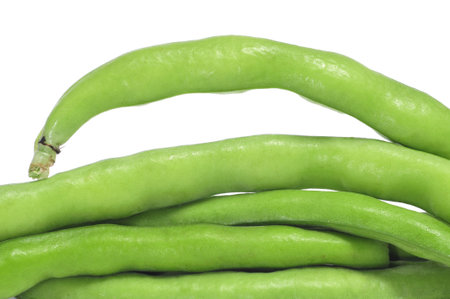 closeup of a pile of french beans on a white background