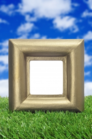 a square golden frame with a blank space on the grassの写真素材