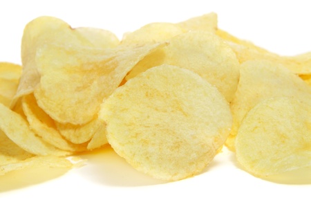 closeup of a pile of potato chips on a white backgroundの写真素材