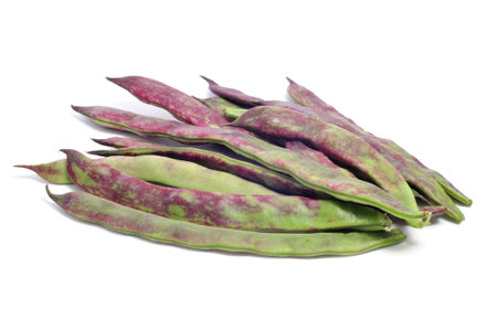a pile of purple french beans on a white background