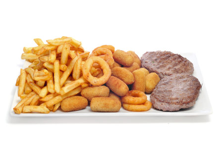 closeup of a tray with fried and fattening food on a white background