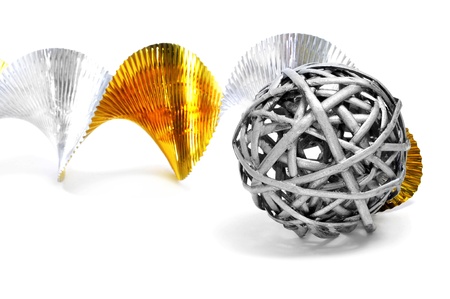 a silver ball and golden and silver garland on a white background の写真素材