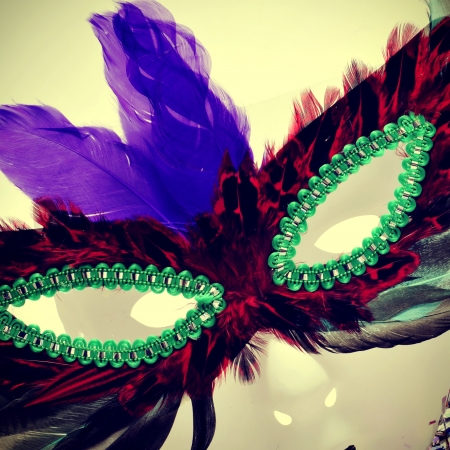 closeup and cutout of a carnival mask with feathers of different colorsの写真素材