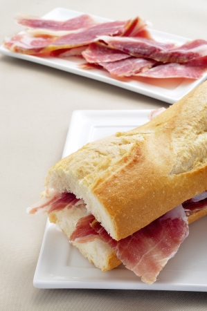 closeup of a spanish serrano ham sandwich in a plateの写真素材
