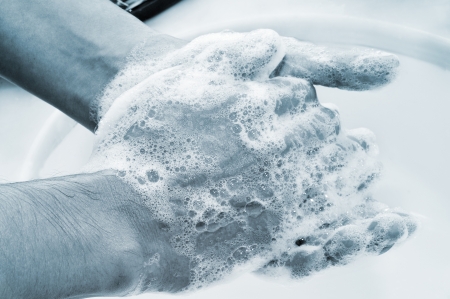 a man washing his hands with soapの写真素材