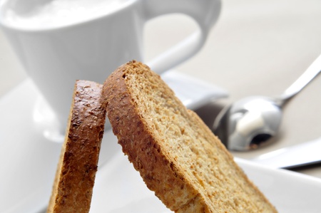breakfast  closeup of some bread rusks and a cup of milkの写真素材