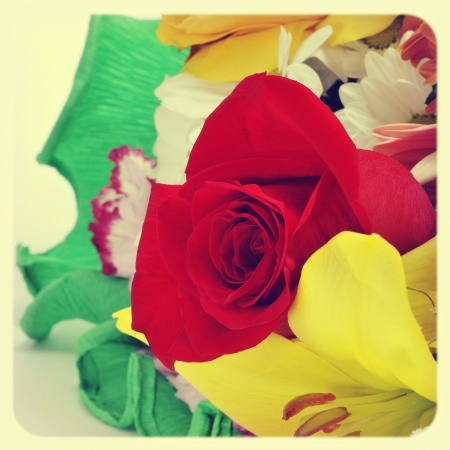 closeup of a flower bouquet with roses, daisies, carnations and other flowers, with a retro effectの写真素材