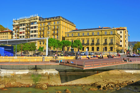San Sebastian, Spain - November 15, 2012: People chilling out in the promenade of La Concha Bay in San Sebastian, Spain. This point is located in Parte Vieja, the old town of the cityのeditorial素材
