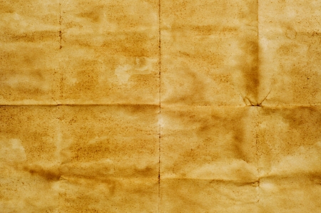 closeup of a yellowish old paper with folding marksの写真素材