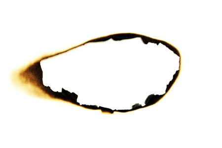 burned hole on a white paper background