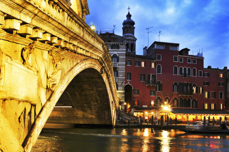 Venice, Italy - April 11, 2013: View of Rialto Bridge and Grand Canal at sunset in Venice, Italy. This main canal is 3800 meter long, 30-90 meters wide, with an average depth of 5 metersのeditorial素材