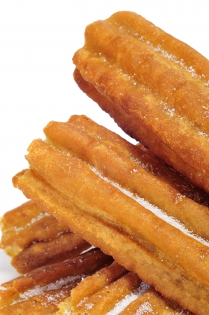 a pile of porras, thick churros typical of Spain, on a white backgroundの写真素材