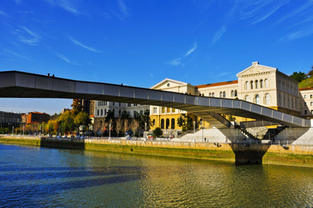 Bilbao, Spain - November 16, 2012  Pedro Arrupe Bridge over the estuary of Bilbao and the University of Deusto in Bilbao, Spain  This footbridge, built in stainless steel, is 140 m longのeditorial素材