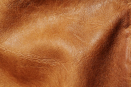 background made of a closeup of wrinkled brown leatherの写真素材