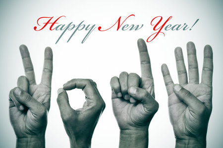 sentence happy new year and hands forming number 2014の写真素材