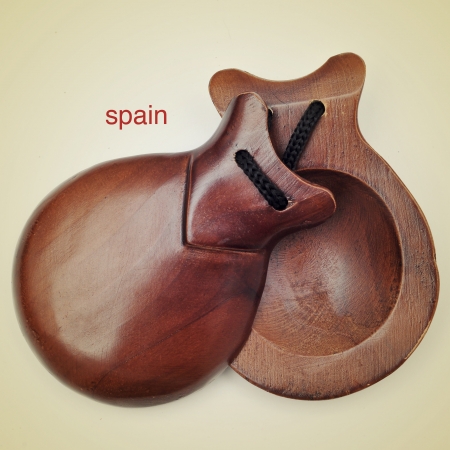 picture of a pair of castanets and the name spain written on a beige background, with a retro effectの写真素材