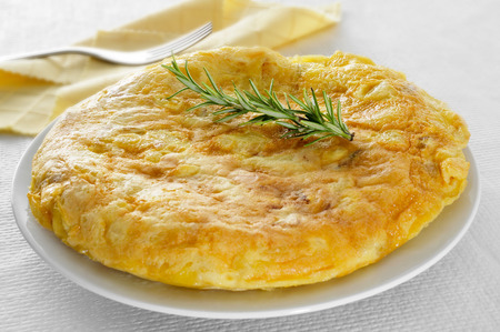 closeup of a plate with a typical tortilla de patatas, spanish omelet, on a set tableの写真素材