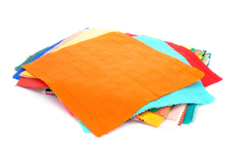square pieces of fabric with different colors and patterns on a white 