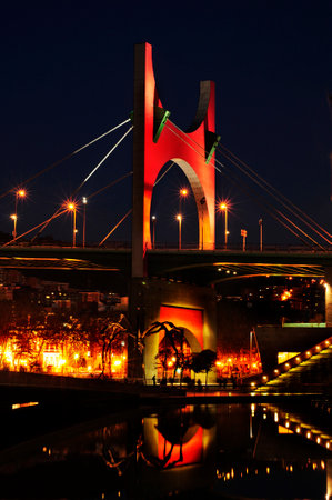 Bilbao, Spain - November 14, 2012  Principes de Espana Bridge in the evening in Bilbao, Spain  The bridge is topped with a red porch designed by french architect Daniel Burenのeditorial素材