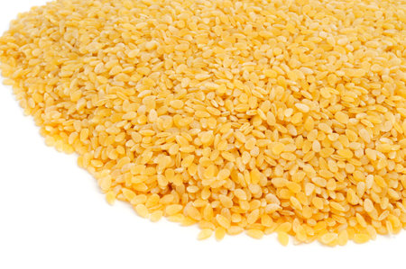 a pile of uncooked pastina, a variety of tiny pieces of pasta used in broth soups, on a white backgroundの写真素材