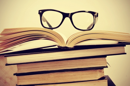 picture of a pile of books and eyeglasses, with a retro effectの写真素材