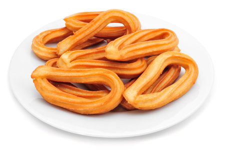 a plate with churros typical of Spain on a white