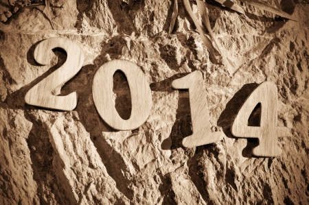 wooden numbers forming 2014, as the new year, on an irregular stone backgroundの写真素材