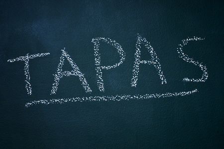 word tapas written witch chalk in a chalkboardの写真素材