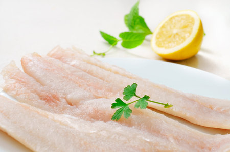 closeup of a plate with some raw pollack fillets