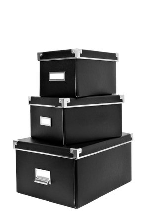a pile of black cardboard storage boxes wtih metal index card holders on a white background