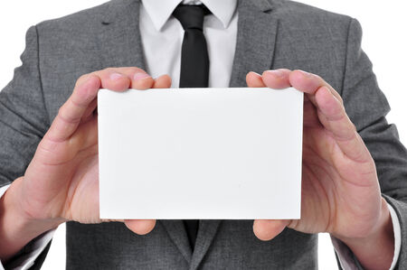 a man wearing a suit showing a blank signboard with a copy-spaceの写真素材